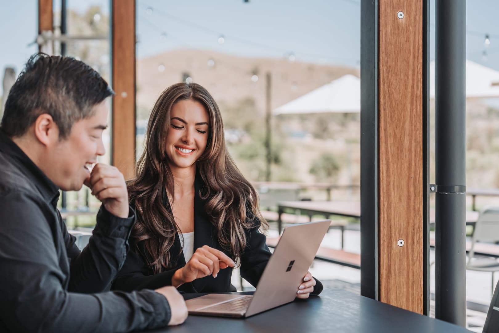 TNL IT consultants working together at a terrace table
