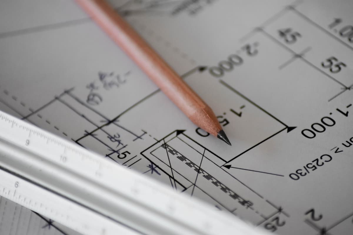 Drafting pencil resting on technical plans
