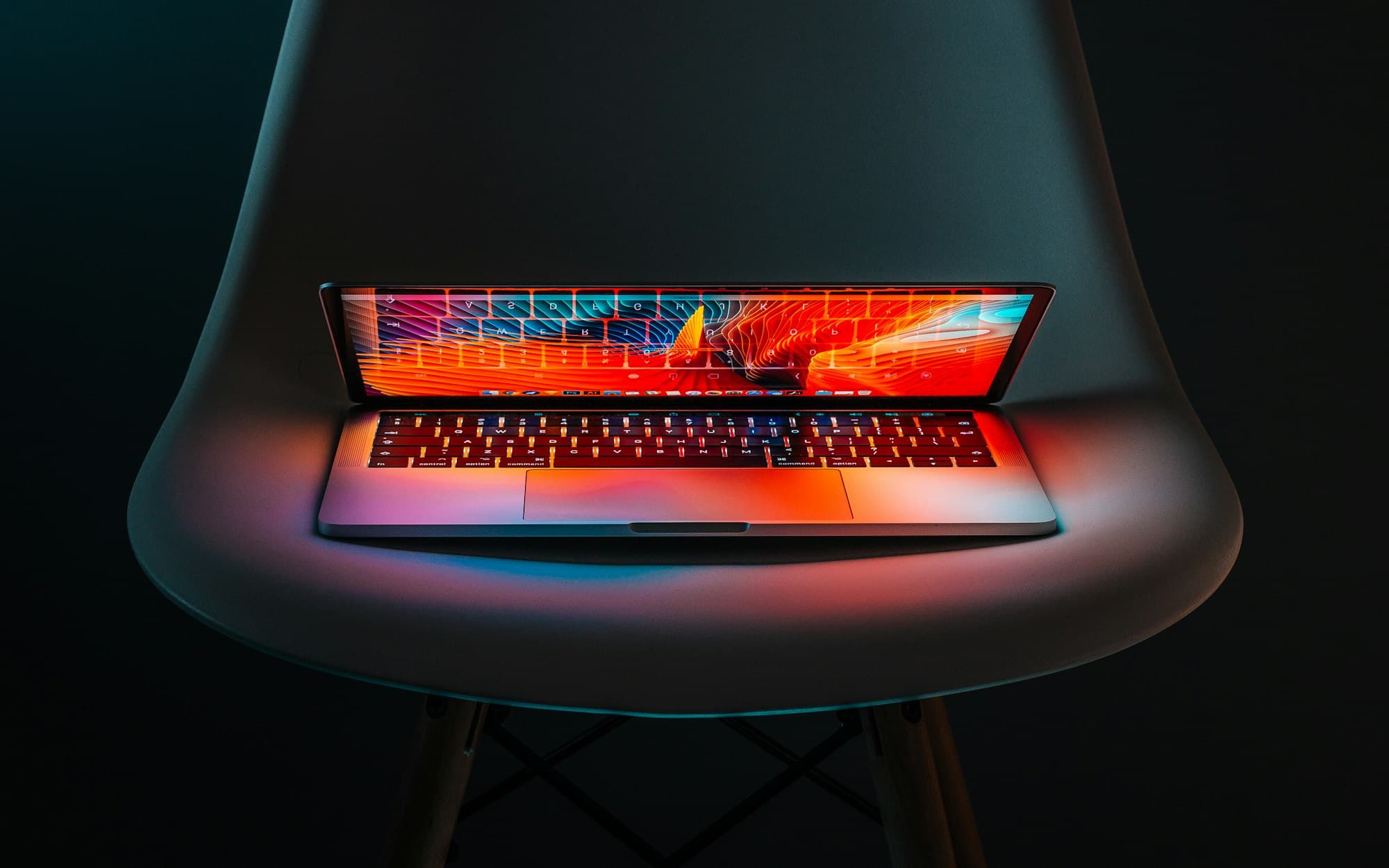 Laptop screen glowing in a dark room